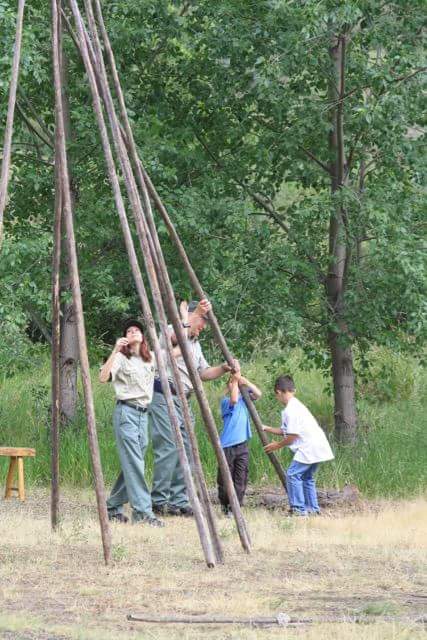  Rangers Vanessa and David demonstrate how to pitch a tipi during summertime River Camp demonstrations. – US Forest Service 