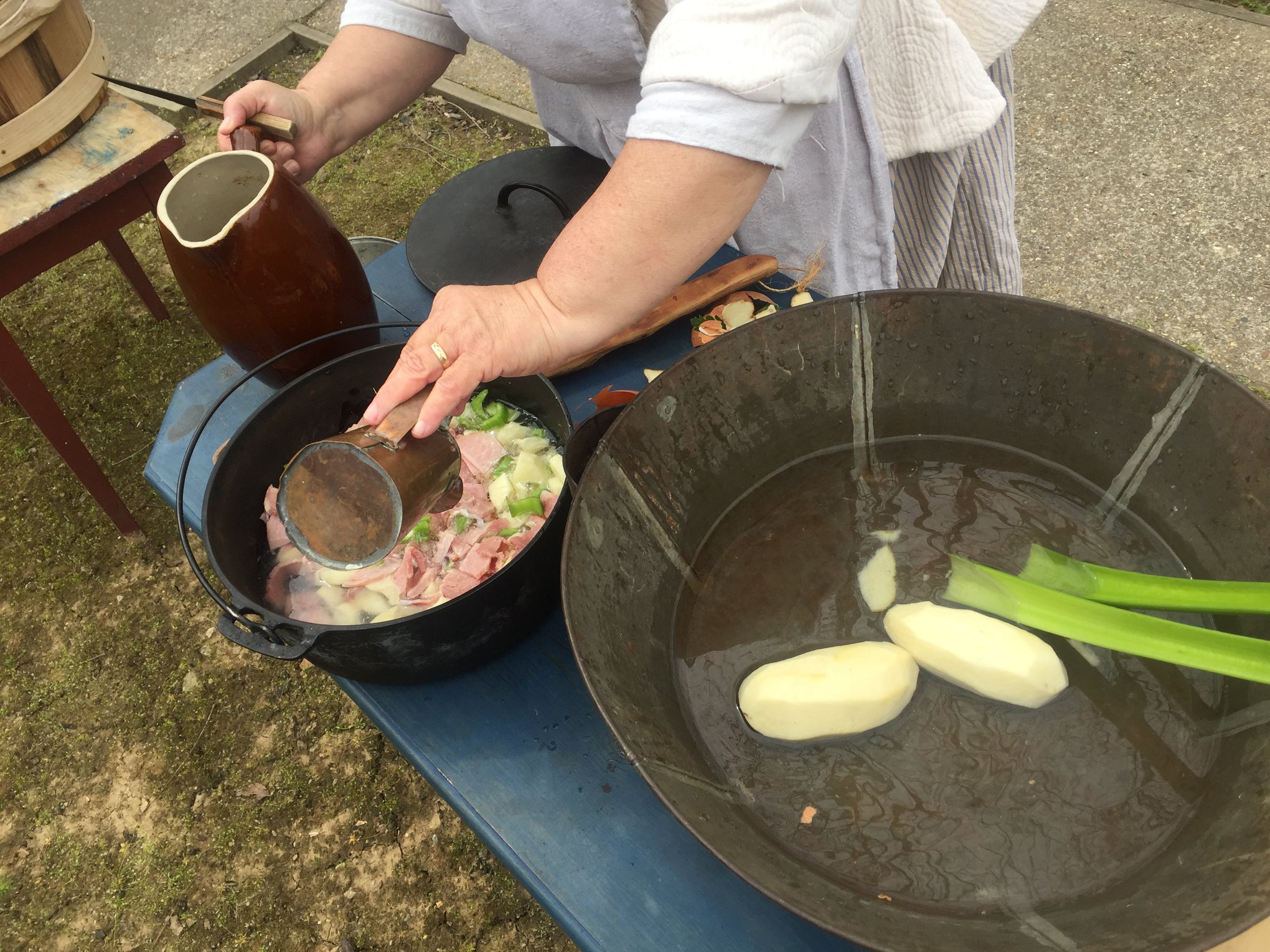 Living history demonstrations behind the Bolduc House show guests how food was prepared during the period. 