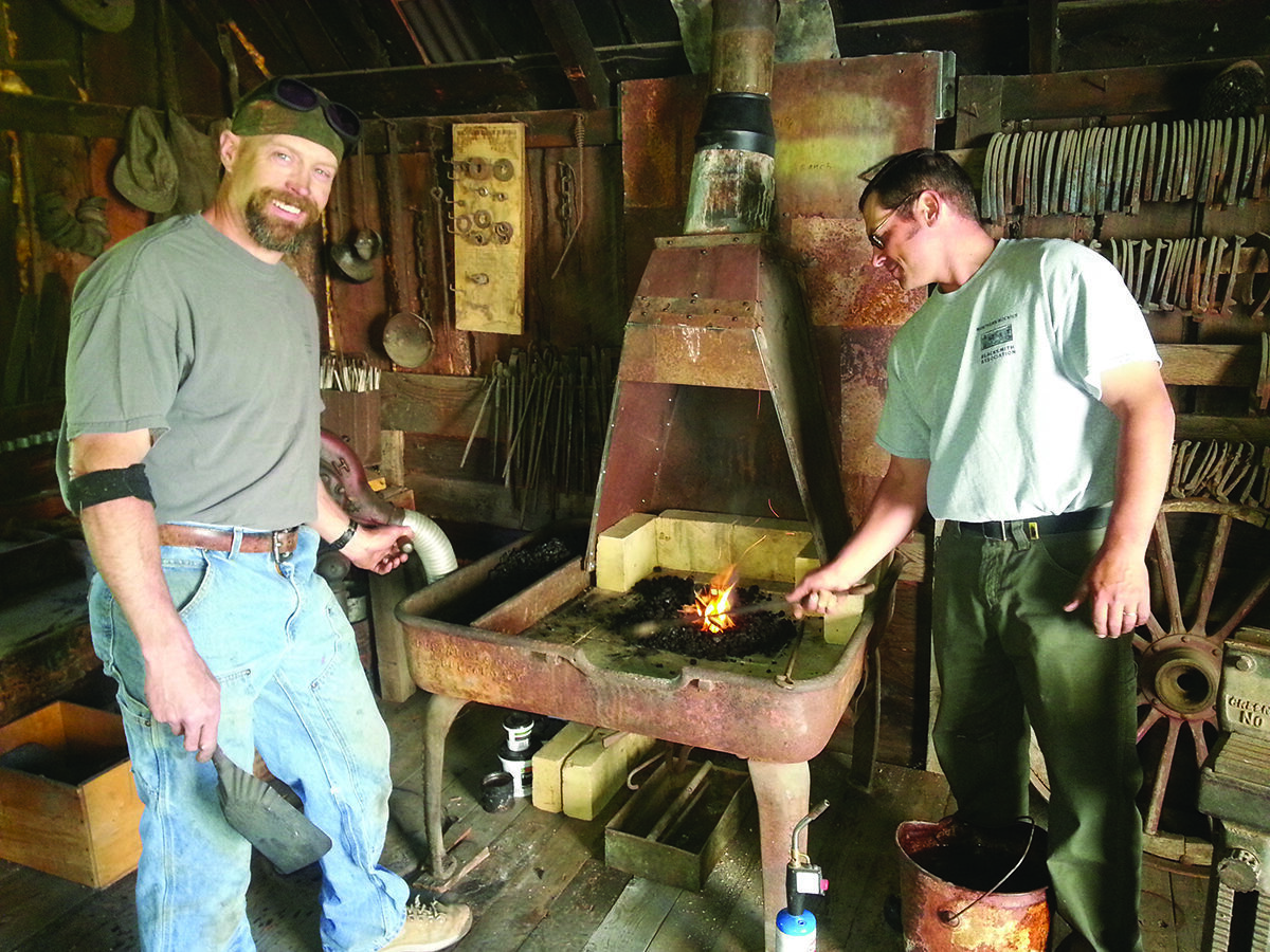 Blacksmiths in museum's blacksmith shop during Living History Day