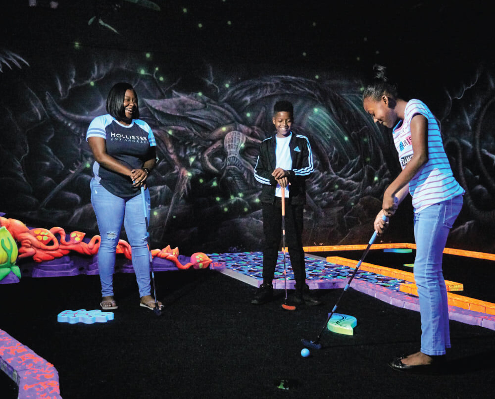 A family plays a round of mini golf at Scene 75 Cincinnati along the Lewis and Clark Historic Trail 