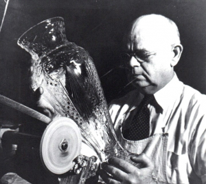 Black and white photo of man holding glass vase